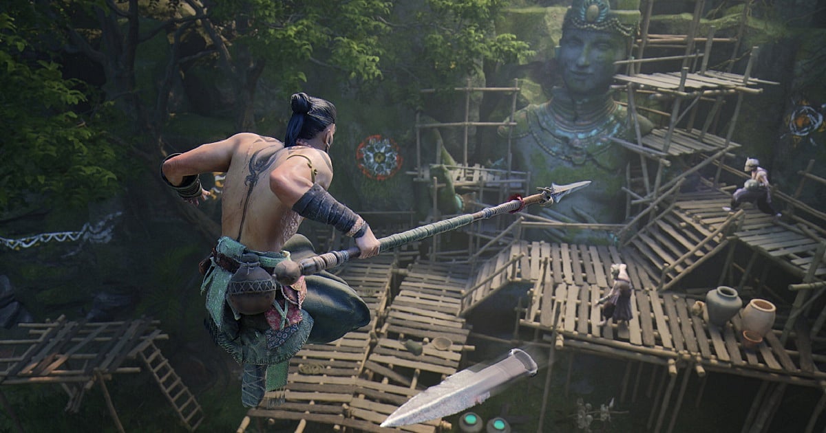 An early gameplay render from The Age of Bhaarat, an upcoming AAA game by Tara Gaming. the screenshot shows the protagonist in a large combat area dodging incoming projectiles while wielding a spear. The area has multiple wooden platforms in front of a large stone statue.