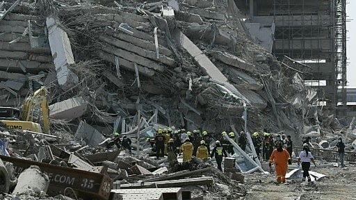 Dozens of workers are trapped after a 30-storey building under construction collapsed following a powerful quake in Bangkok - null