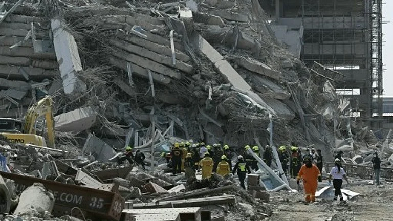 Dozens of workers are trapped after a 30-storey building under construction collapsed following a powerful quake in Bangkok - null