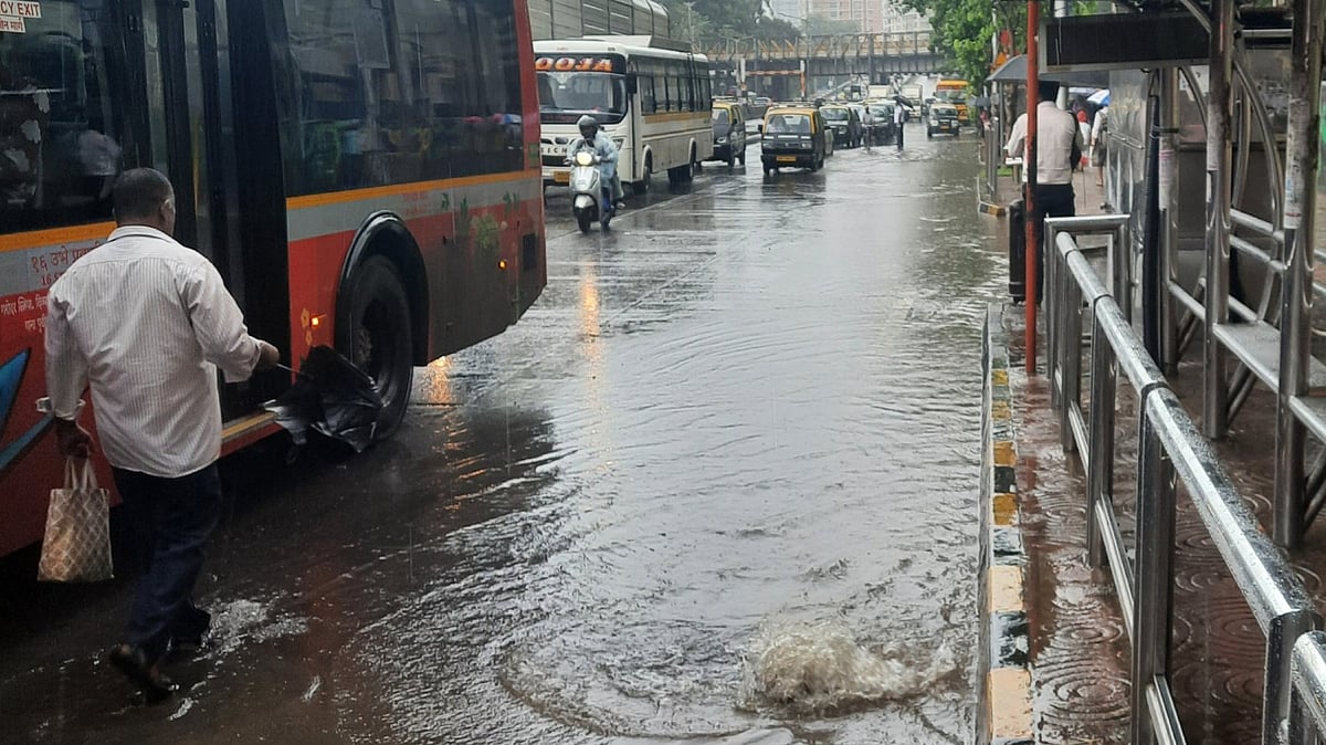 X/@GalaJenish : Waterlogged streets slow down buses and pedestrians in Mumbai after IMD issues an orange alert amid heavy rainfall on June 16.