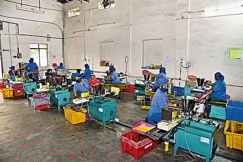 Workers at a Cycle Agarbathi production unit