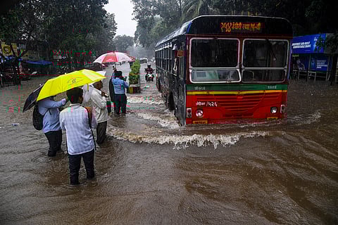 Heavy rains cause waterlogging as people commute through flooded streets in Mumbai