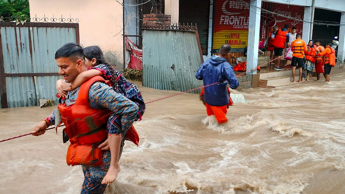 Photo by PTI : Rescue teams navigate flooded streets in Punjab after heavy monsoon rains