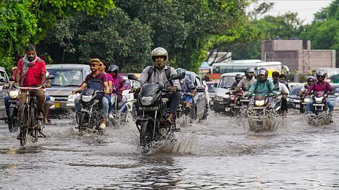 Vehicles navigate waterlogged roads amid heavy rainfall in Delhi
