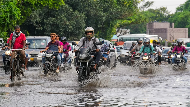 Vehicles navigate waterlogged roads amid heavy rainfall in Delhi