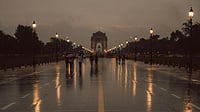 Photo by Pramod  Tiwari : People walk with umbrellas during sudden October rain in New Delhi