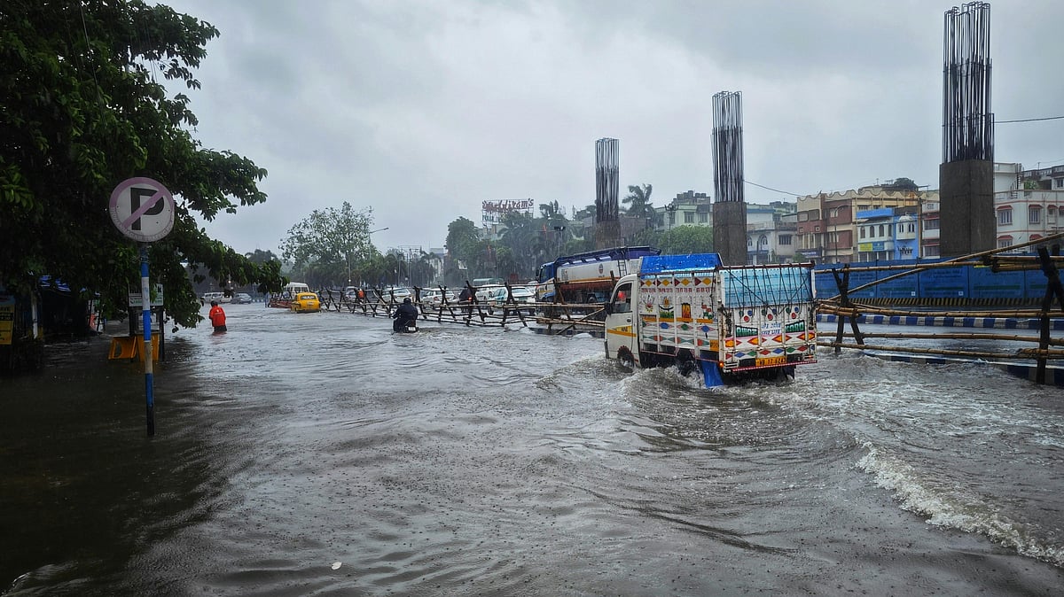 Photo by Dibakar Roy : Cars driving through a flooded street in West Bengal