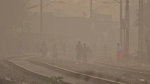 Photo by PTI : Residents walking in dense smog due to severe air pollution in Delhi