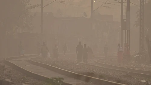 Photo by PTI : Residents walking in dense smog due to severe air pollution in Delhi