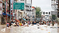Image by AP : Rescue teams work amid floodwaters in Southeast Asia after devastating cyclones