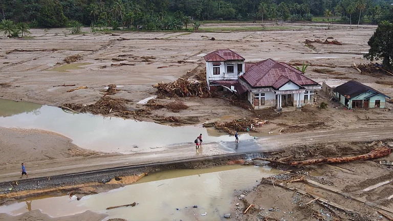 Relief workers navigate floodwaters caused by supercharged tropical storms in Southeast Asia - Photo by Associated Press