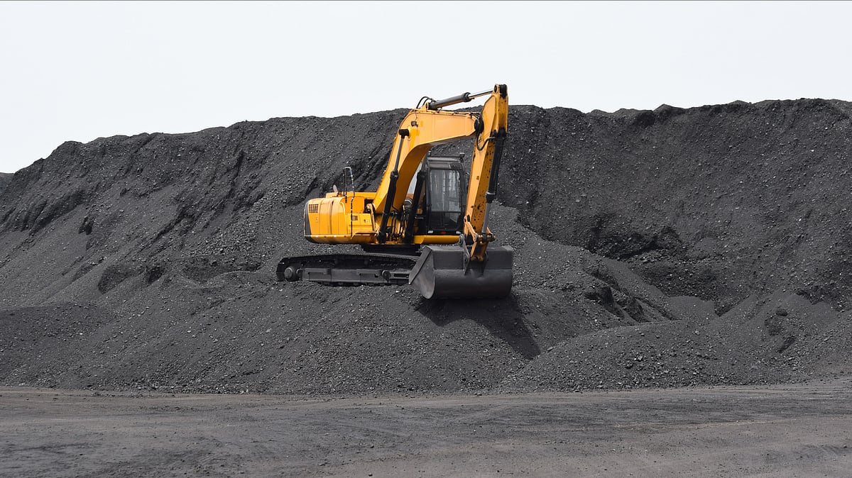 Digger working on the bulk mountain of coal - null