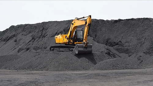 Digger working on the bulk mountain of coal