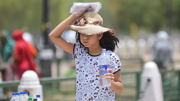 People shield themselves from intense heat as temperatures soar across Delhi in early March - null