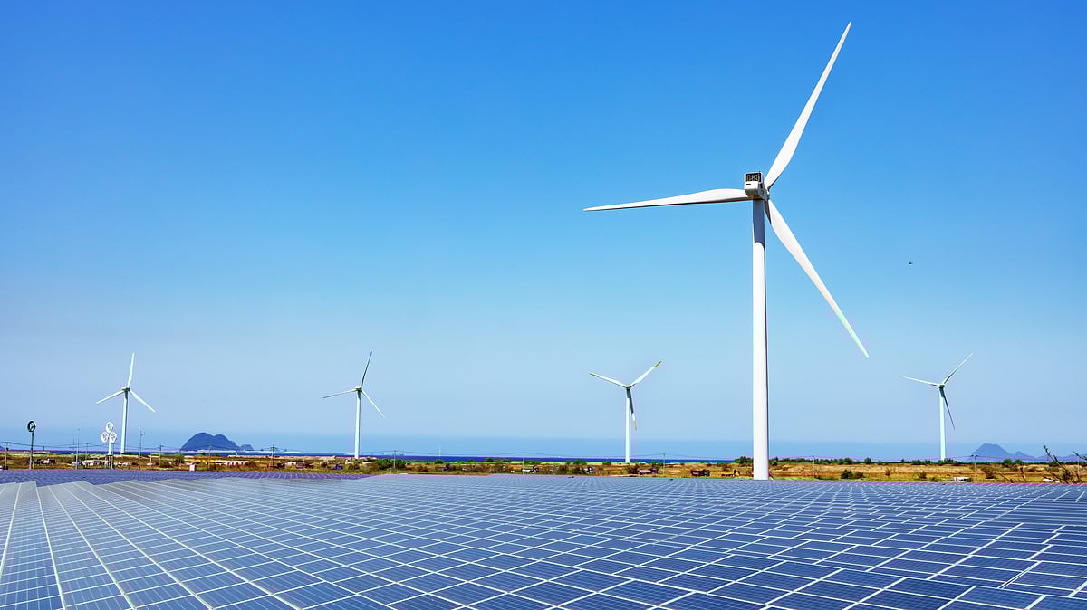 Solar panels and wind turbines installed across a renewable energy park - null