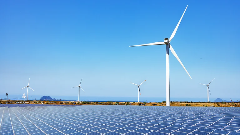 Solar panels and wind turbines installed across a renewable energy park - null