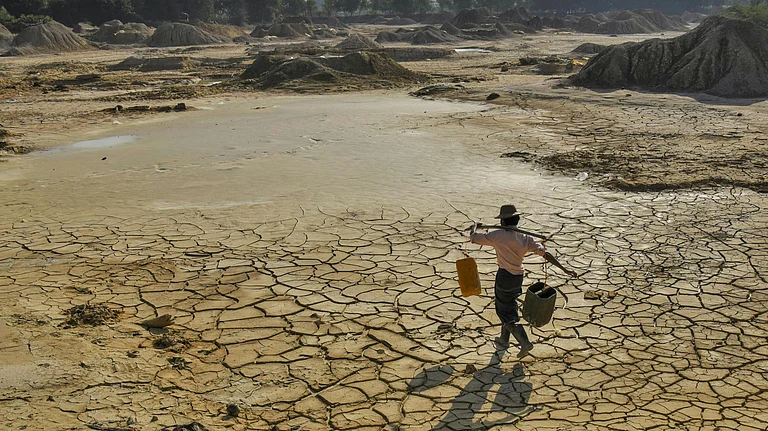 Man carries water in a water-stressed region - null