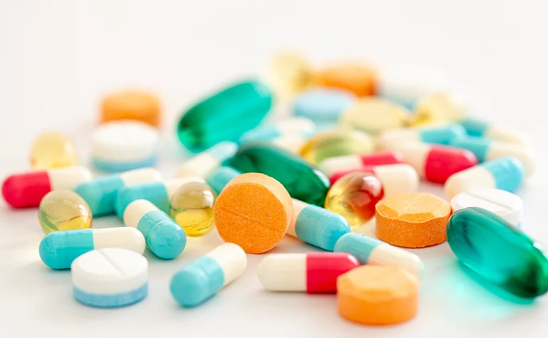 Pharmaceutical production line with medicine vials representing industry supply pressures - null