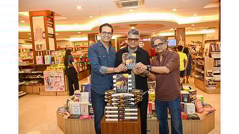 Ajit and Anil holding copies of The Dealer