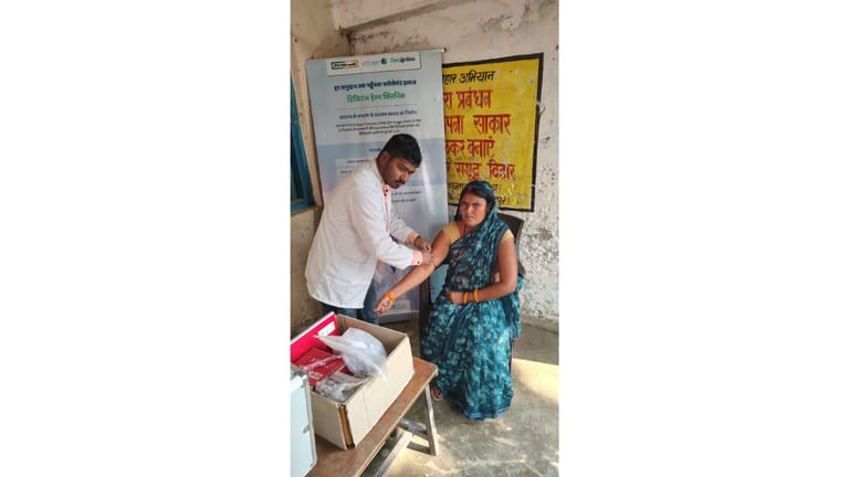 Doctor checking woman's arm in a rural clinic - null