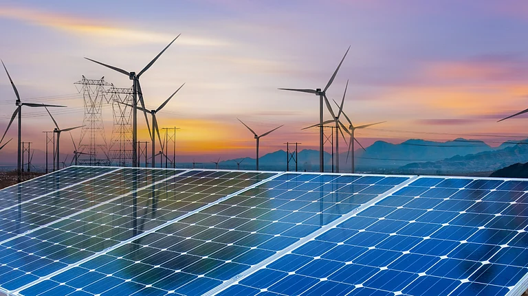 Solar panels and wind turbines symbolising the global shift toward renewable energy - null