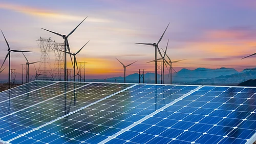 Solar panels and wind turbines symbolising the global shift toward renewable energy