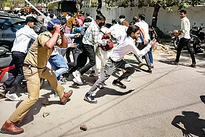 | Photo: PTI : Police chase away protestors