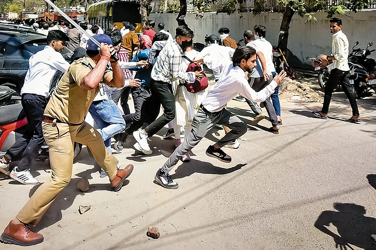 Police chase away protestors - | Photo: PTI