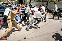 | Photo: PTI : Police chase away protestors