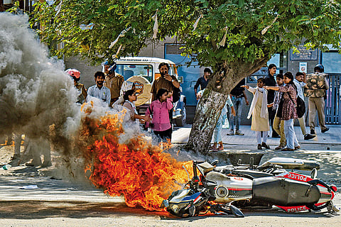 Agitating workers burn vehicles