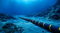 Illustration of undersea internet cables connecting global digital infrastructure routes across oceans