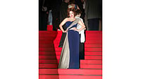 Actress Meet Kaur poses in a navy blue and silver gown at the 79th Cannes Film Festival red carpet