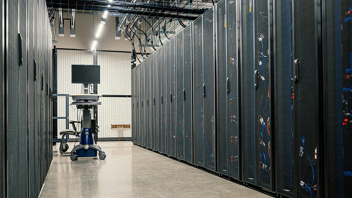 Rows of servers inside a modern data centre supporting cloud computing and AI workloads - null