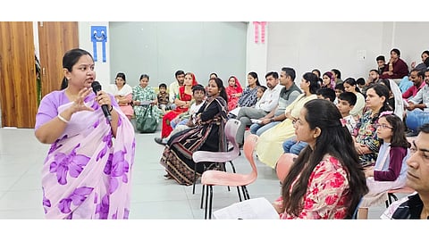 Dr. Vini Jhariya addressing a seated audience.
