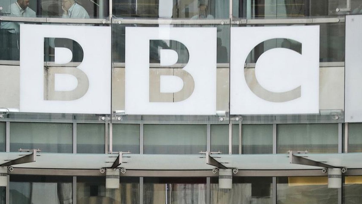 BBC sign outside entrance to headquarters of publicly funded media organisation in London