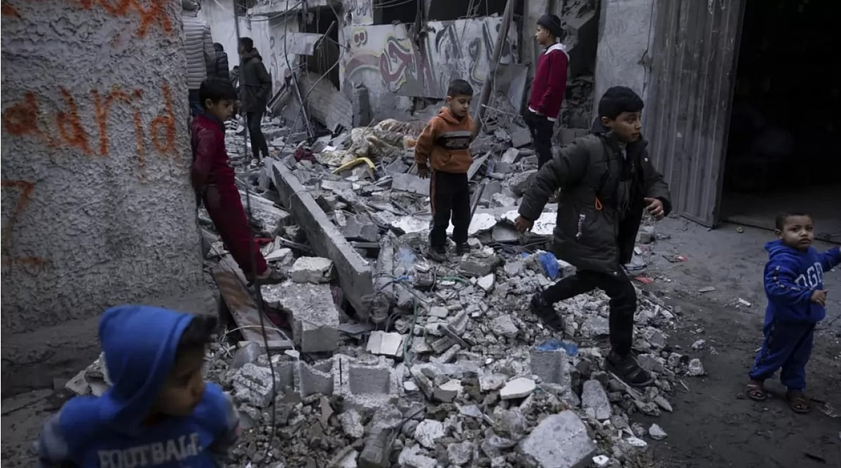 Palestinians look at the destruction after an Israeli strike in southern Gaza Strip  - AP