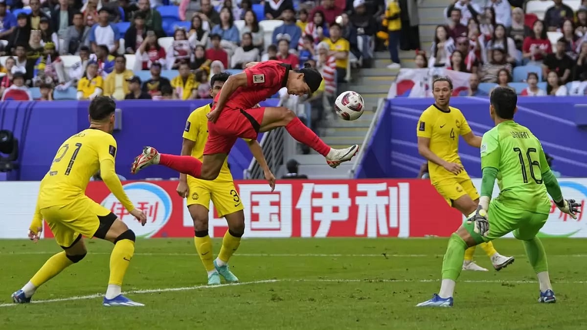 AP : South Korea's Cho Gue-sung, centre, heads the ball in an attempt to score during the Asian Cup Group E football match between South Korea and Malaysia
