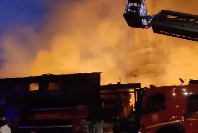 Screen grab from video posted on X/@ANI : A mall adjacent to the building on fire had to be evacuated