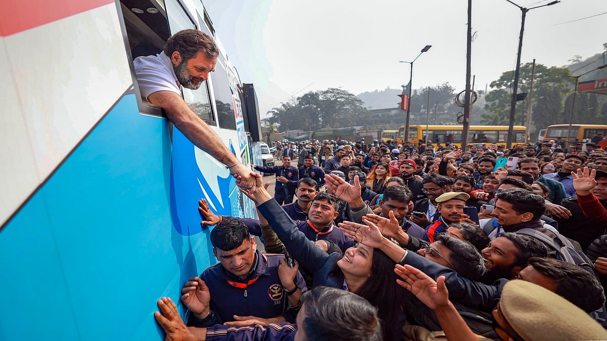 PTI : Congress leader Rahul Gandhi shakes hand with supporters in Assam 
