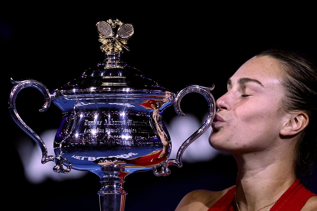 AP Photo : Aryna Sabalenka of Belarus kisses the Daphne Akhurst Memorial Cup after defeating Zheng Qinwen of China in the women's singles final of the Australian Open 2024 at Melbourne Park, Melbourne on January 27, 2024.