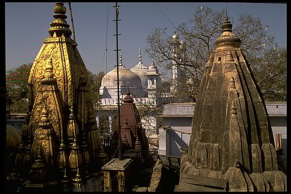 Golden top of Hindu Vishwanath temple framed by Muslim Gyanvapi Mosque - Photo by Robert Nickelsberg/Getty Images
