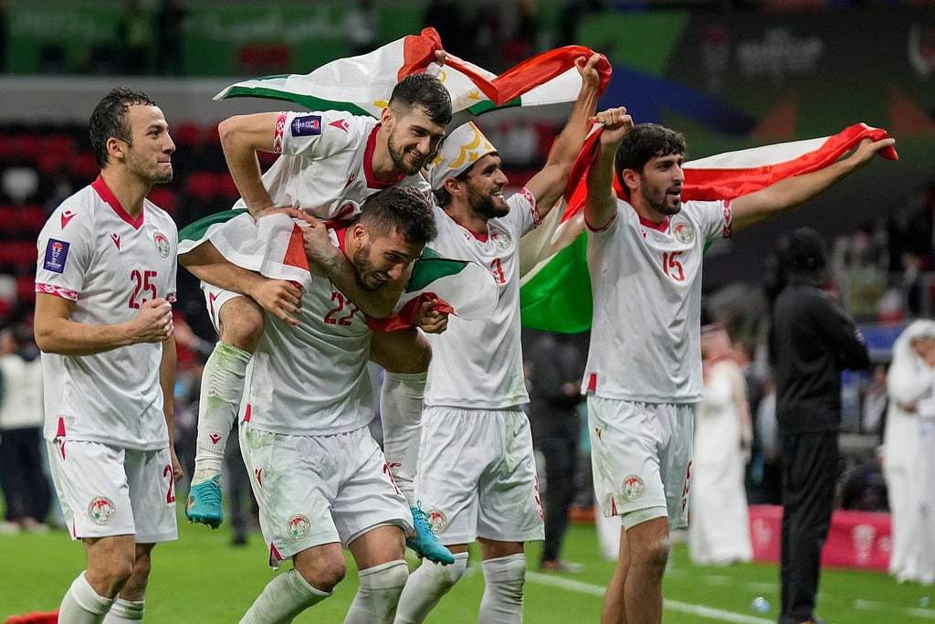 AP : Tajikistan players celebrate after winning their AFC Asian Cup 2023 round of 16 football match against United Arab Emirates at Ahmad Bin Ali Stadium in Doha, Qatar.