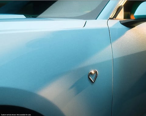 Sweeney’s robin’s-egg blue Mustang with a custom heart-shaped emblem.