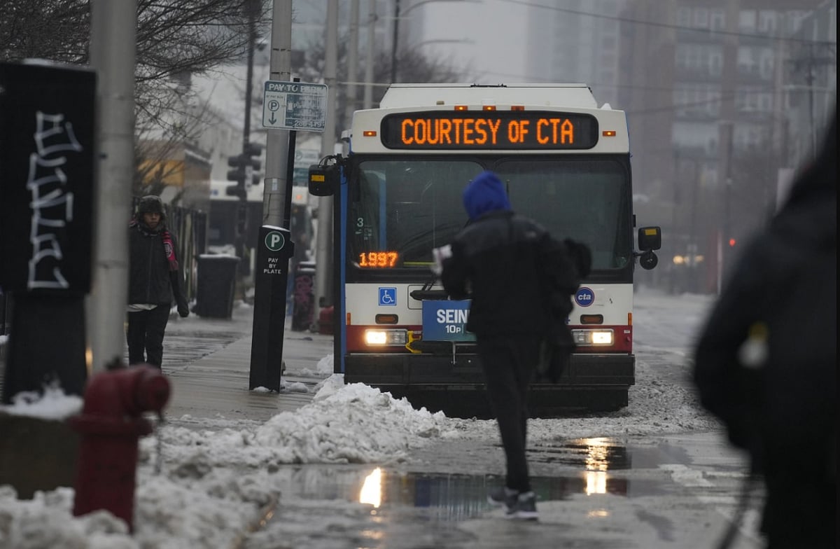 Credit: AP : Dozens of asylum-seekers are staying in the lower level of a city library until the bitter cold gripping much of the country lifts. 