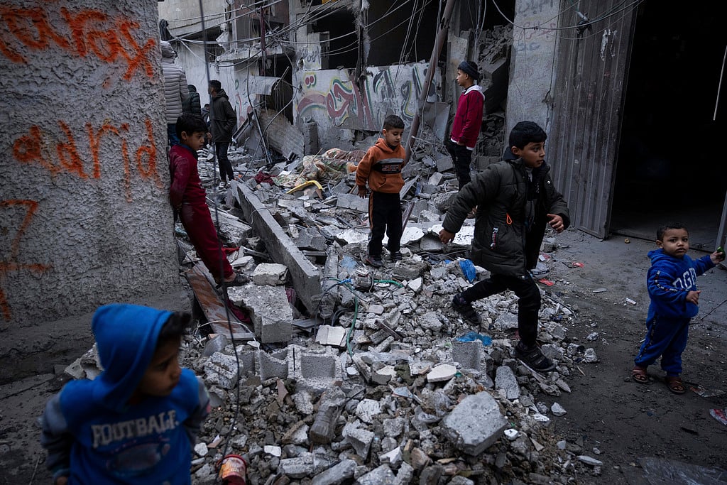 AP : Palestinians look at the destruction after an Israeli strike in Rafah, southern Gaza Strip