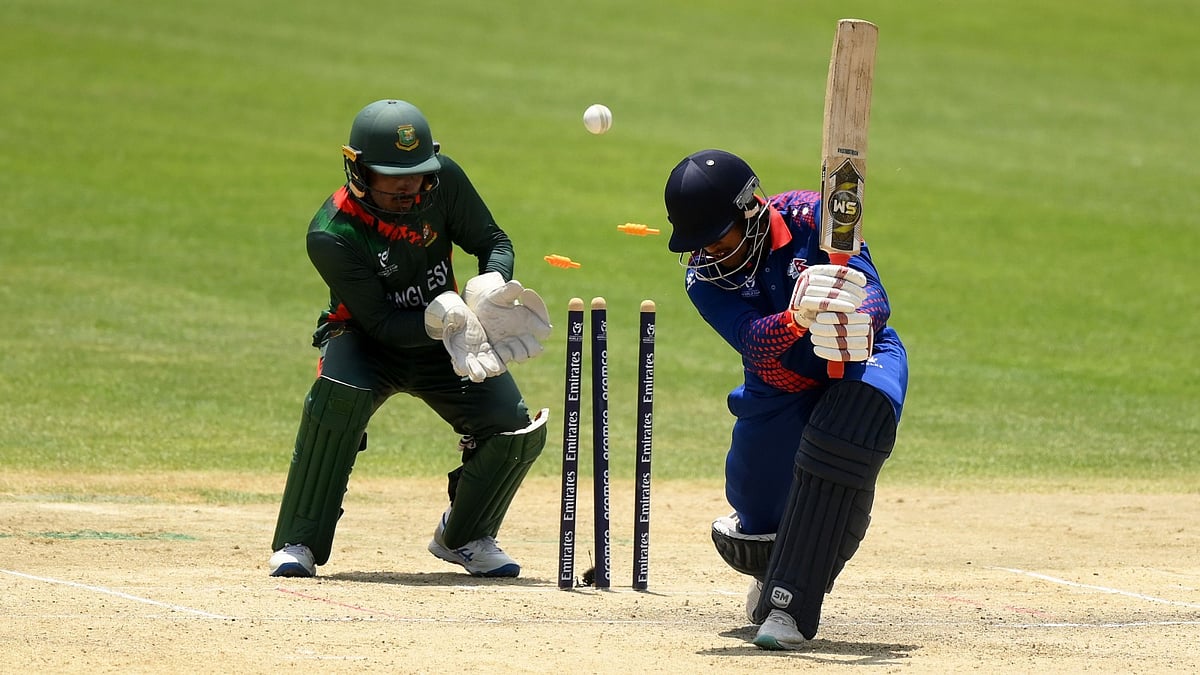 ICC Photo : Dipak Bohara of Nepal is bowled out by Sheikh Jibon of Bangladesh as Ashiqur Rahaman Shibli of Bangladesh looks on during the ICC U19 Men's Cricket World Cup South Africa 2024 Super Six match between Nepal and Bangladesh on January 31, 2024.