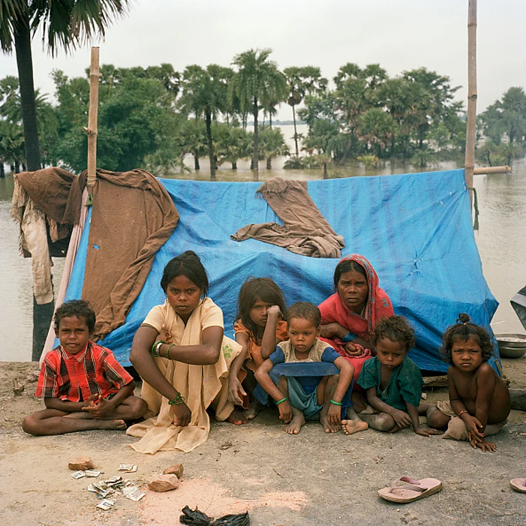Belonging to the Musahar community (backward caste), these two women who had to flee their villages twice due to flooding, are forced to stay in makeshift plastic shelters set up on a road embankment in Bihar.
- Getty Images