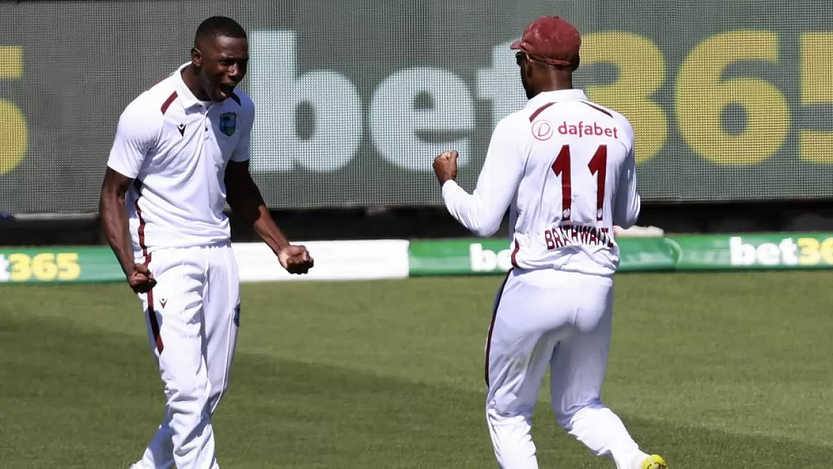 AP : Shamar Joseph, left, celebrates with teammate Kraigg Brathwaite after taking the wicket of Steve Smith on the first day of the cricket Test match between West Indies and Australia in Adelaide