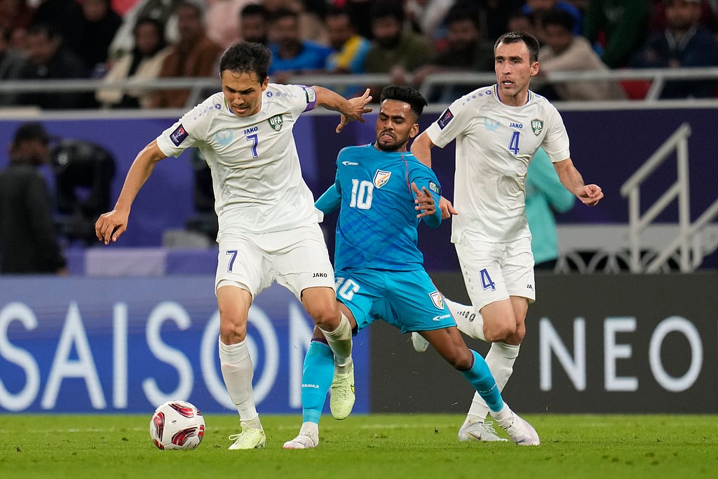 AP : India's Brandon Fernandes, centre, tries to stop Uzbekistan's Otabek Shukurov, left, during the Asian Cup Group B football match 
