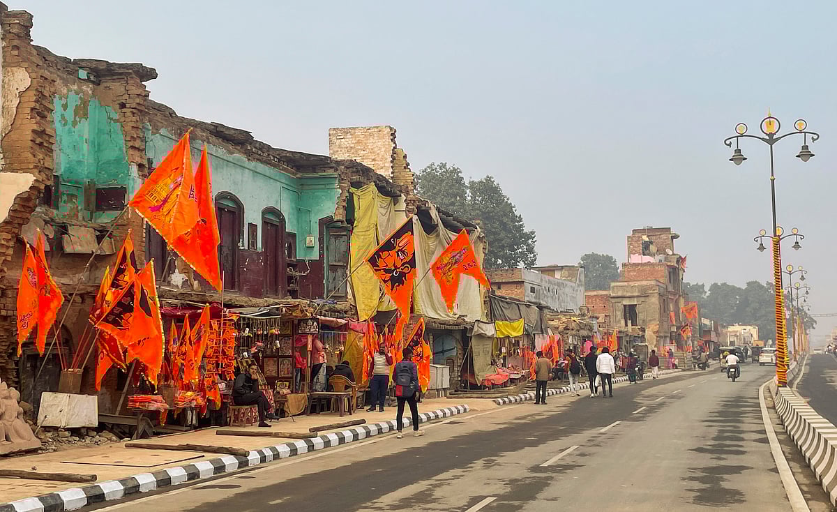 PTI Photo/Kunal Dutt : Saffron flags bearing images of Lord Ram, Lord Hanuman and the upcoming grand temple on display along Ram Path, in Ayodhya.